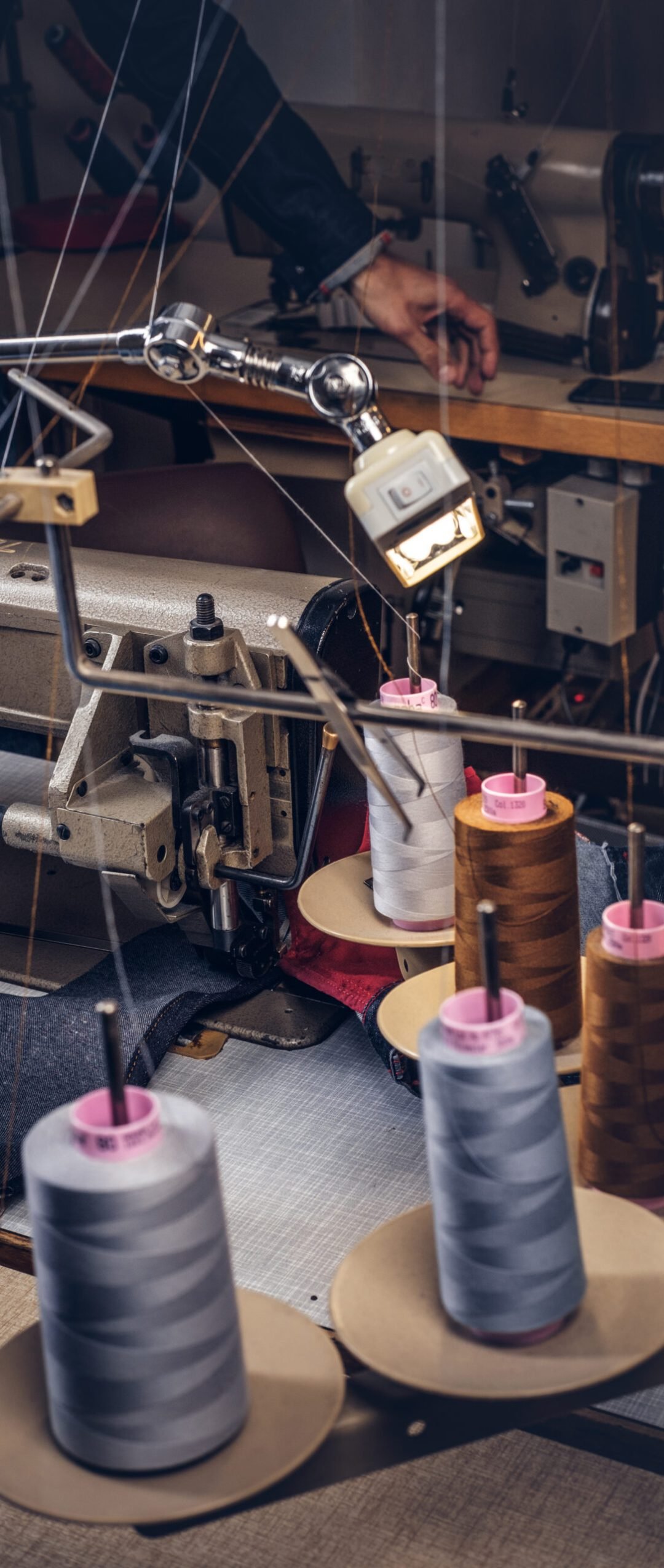 Picture of a tailor's desktop at a sewing workshop.